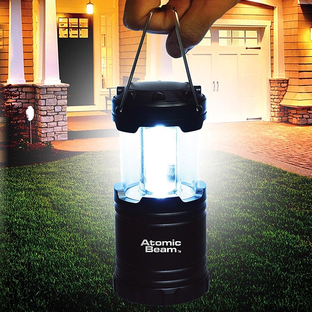 Atomic Beam Lantern with the light on held up in front of a house