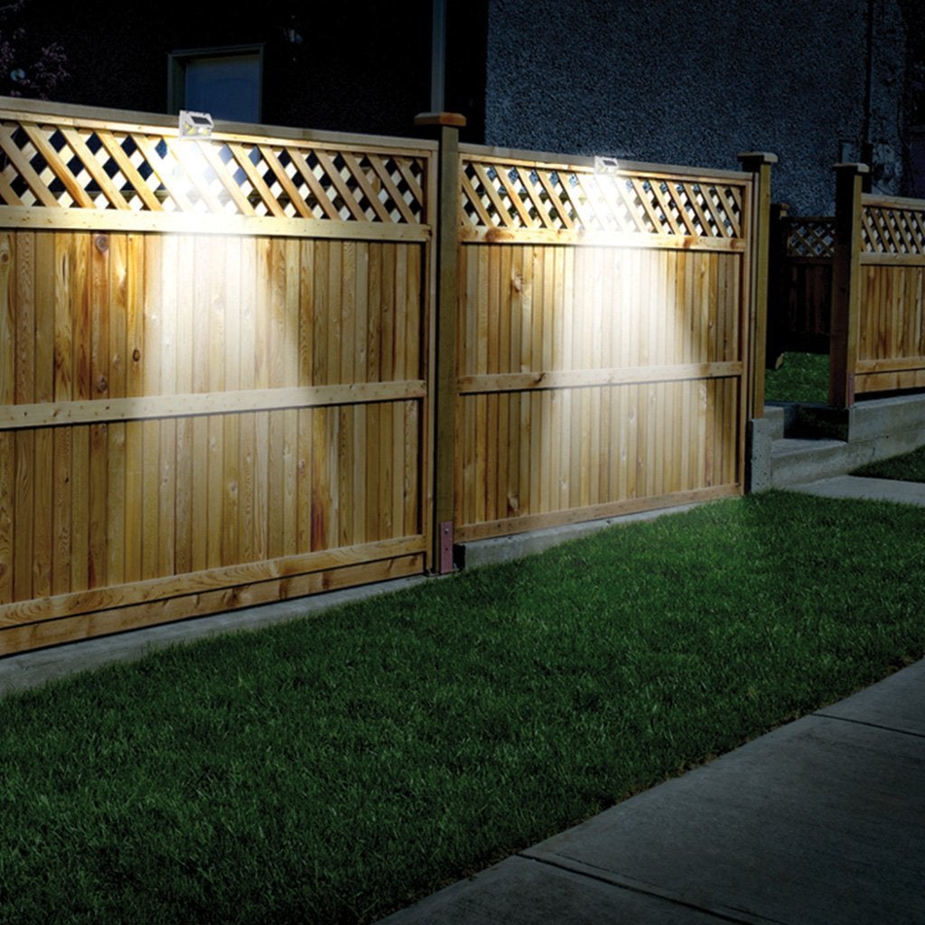 Atomic Beam SunBlast Motion Sensor Light on top of a fence with the light on