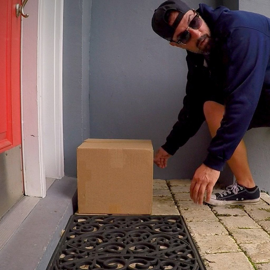 Man attempting to steal a package from someone's front door