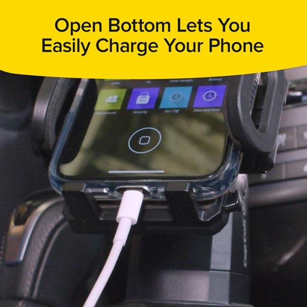 Close up of a smart phone with a phone charging cable plugged into the bottom while sitting in a Cup Call in a car. Text says open bottom lets you easily charge your phone