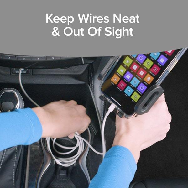 Close up of woman holding a Cup Call with a smart in it that has a phone charging cable plugged into it, she is putting the excess cable into the cup holder before placing the Cup Call in. Text says keep wires neat and out of sight