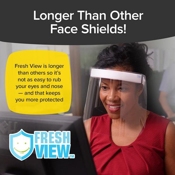 Woman wearing Fresh View Face Shield looking at a laptop. Headlines say Longer than other face shields, Fresh View is longer than others so it's not as easy to rub your eyes and nose and that keeps you more protected