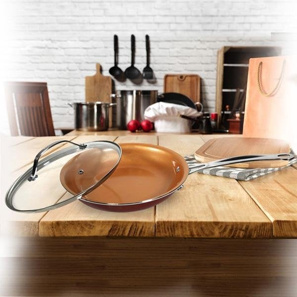Red Copper Round Lid on pan on cutting board in kitchen