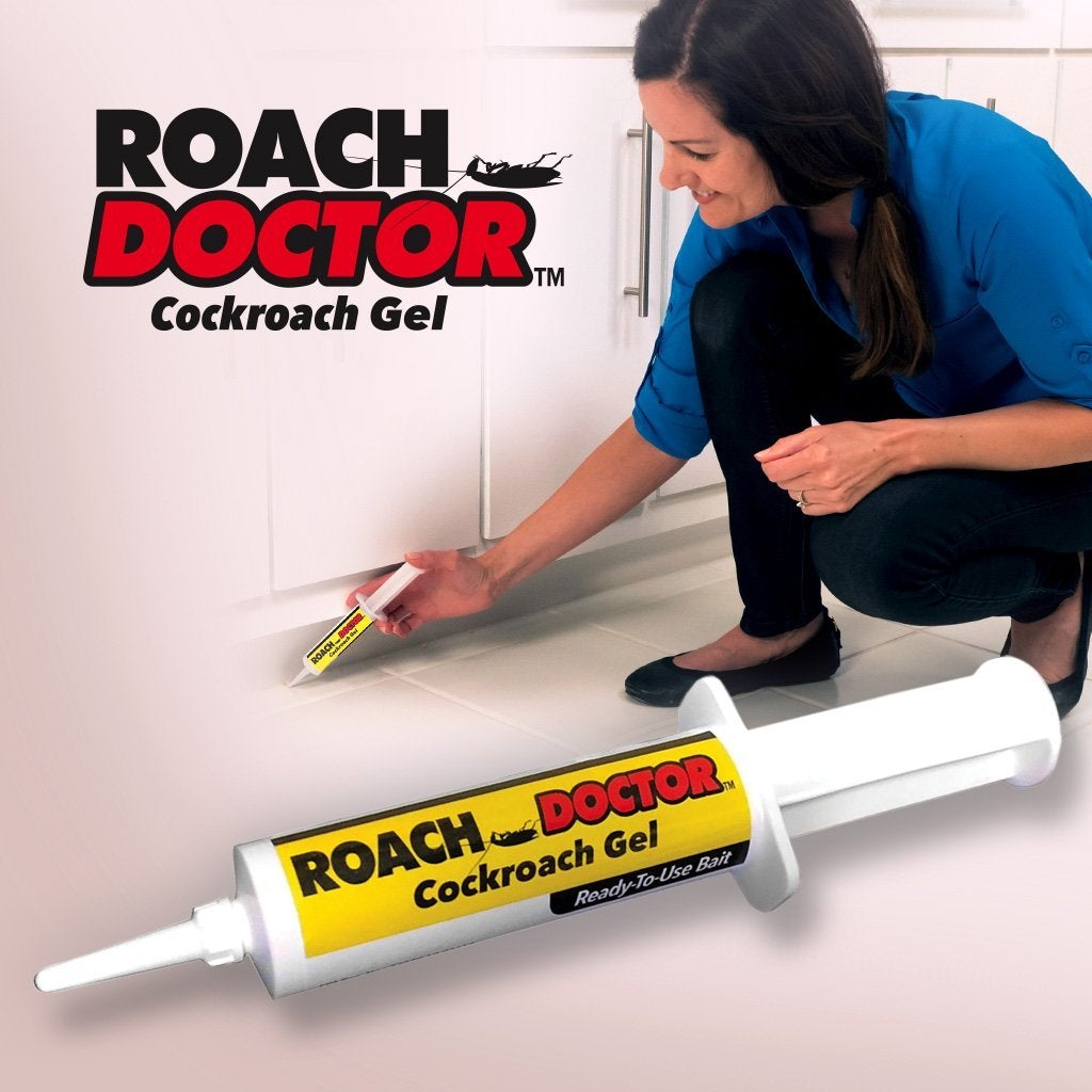 Woman applying Roach Doctor under cabinets